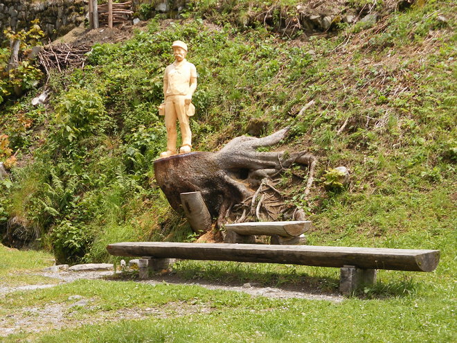 Jolie sculpture de bois sur la souche d'un arbre à l'arrêt de Planalp ! Achtung , le chef de gare vous surveille de son piedestal !.JPG