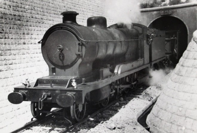 930 - HBT War Dpt (exLNER Robinson Class 04) 2 8 0 steam loc emerging from rosh hanickra in WWII.jpg