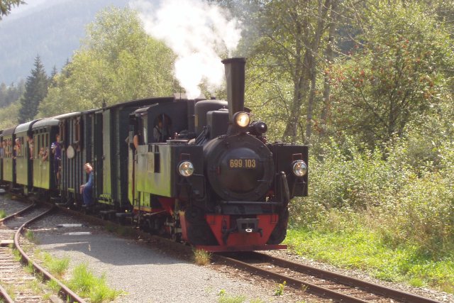 la 699.103 de l'ÖGEG en tête d'une rame de voitures à plateformes ouvertes arrive en gare en tête du train touristique du 17 août 2003